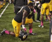 College football player kneeling
