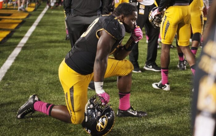 College football player kneeling