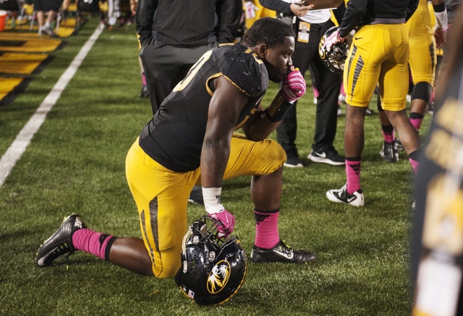 College football player kneeling