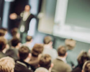 Large Group of People Listening to a Presentation