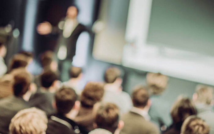 Large Group of People Listening to a Presentation