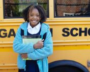 Schoolgirl in front of bus