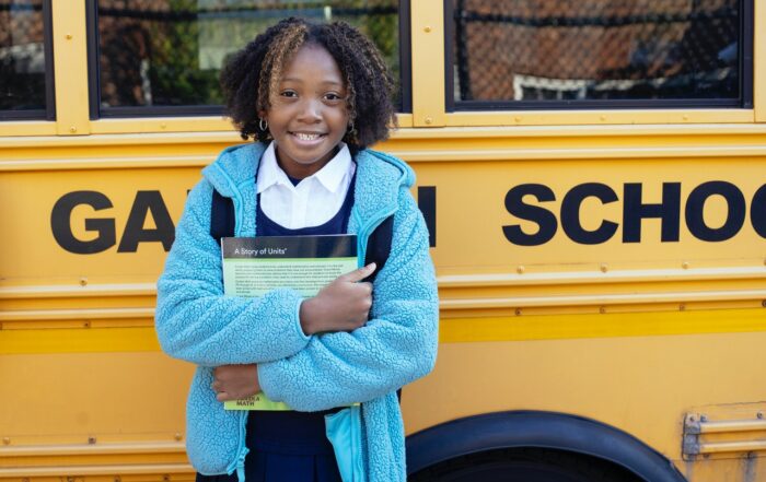 Schoolgirl in front of bus
