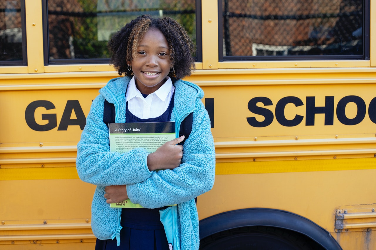 Schoolgirl in front of bus